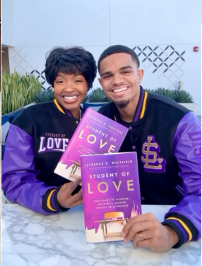A couple wearing Student of Love jackets and displaying their books