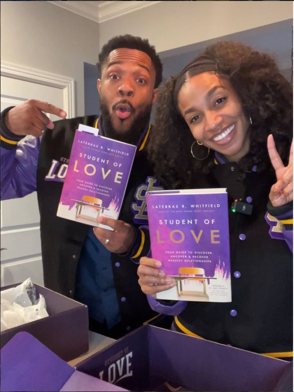 A couple showing their Student of Love books and varsity jackets