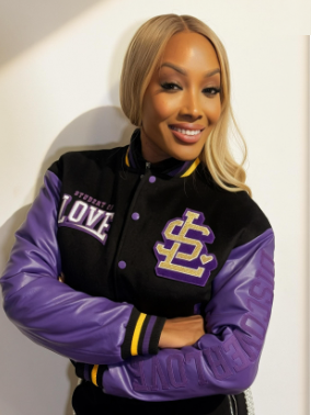 A woman wearing the Student of Love varsity jacket