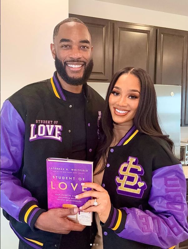 A couple wearing Student of Love varsity jackets and holding the book