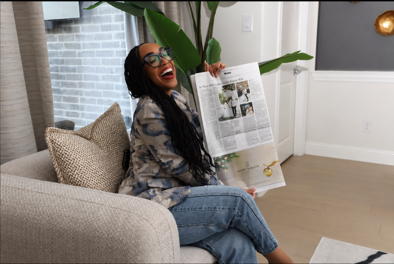 A woman holding the newspaper feature about Laterras and Ashley’s wedding